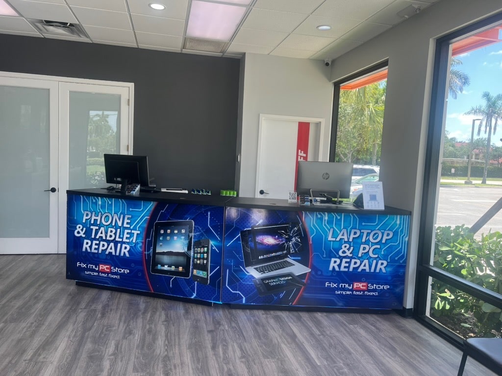Branded customer intake counter inside Fix My PC Store
